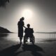 Social care carer and person in wheelchair looking out to sea
