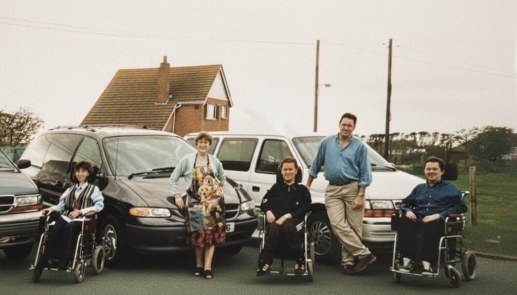1990s family photo of Colin Hughes with siblings Ian and Lyn; three wheelchair-accessible Motability Chrysler Voyager vehicles behind them.