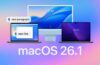Voice Control in macOS 26.1 graphic showing a MacBook and iMac on a blue gradient background, with microphone icons beside the commands “Delete that”, “Lower case that”, and “New line”, illustrating accessibility and Voice Control improvements.