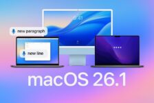 Voice Control in macOS 26.1 graphic showing a MacBook and iMac on a blue gradient background, with microphone icons beside the commands “Delete that”, “Lower case that”, and “New line”, illustrating accessibility and Voice Control improvements.