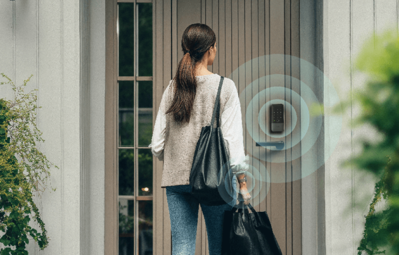 Person approaching a front door with an Aqara smart lock, illustrated with wireless proximity rings to show hands-free unlocking using Ultra Wideband technology.