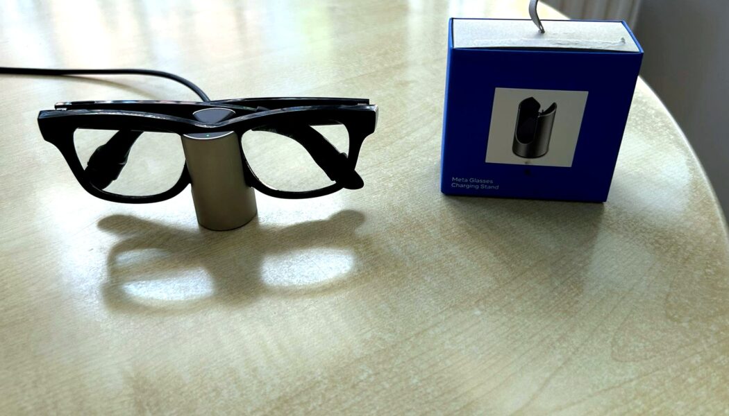 Meta Glasses Charging Stand review image with Ray-Ban Meta smart glasses charging beside the retail box