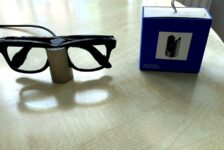 Meta Glasses Charging Stand review image with Ray-Ban Meta smart glasses charging beside the retail box