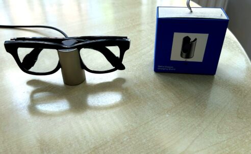 Meta Glasses Charging Stand review image with Ray-Ban Meta smart glasses charging beside the retail box