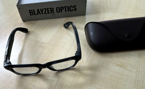 Ray-Ban Meta Blayzer Optics smart glasses on a table with charging case and box for a Ray-Ban Meta Blayzer Optics review.