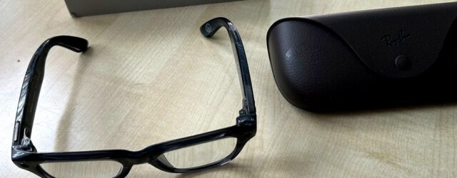 Ray-Ban Meta Blayzer Optics smart glasses on a table with charging case and box for a Ray-Ban Meta Blayzer Optics review.