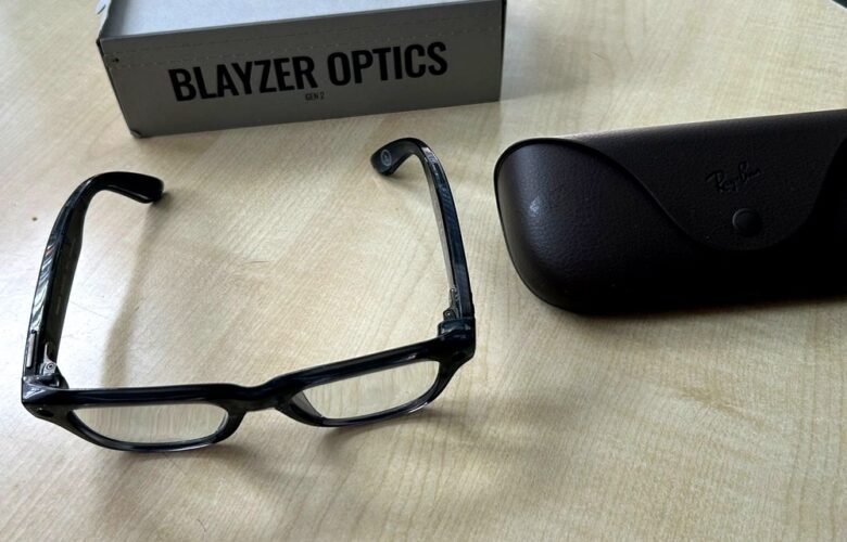Ray-Ban Meta Blayzer Optics smart glasses on a table with charging case and box for a Ray-Ban Meta Blayzer Optics review.