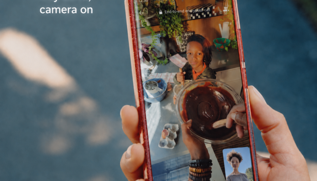 Meta smart glasses call controls shown during a WhatsApp point-of-view video call with the command “Hey Meta, camera on”.