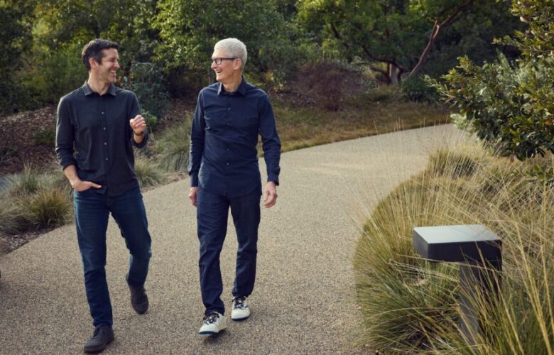 Tim Cook and John Ternus walking together at Apple Park in April 2026