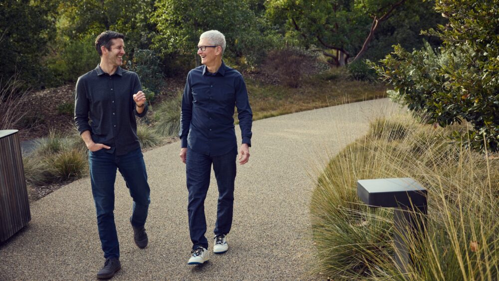 Tim Cook and John Ternus walking together at Apple Park in April 2026
